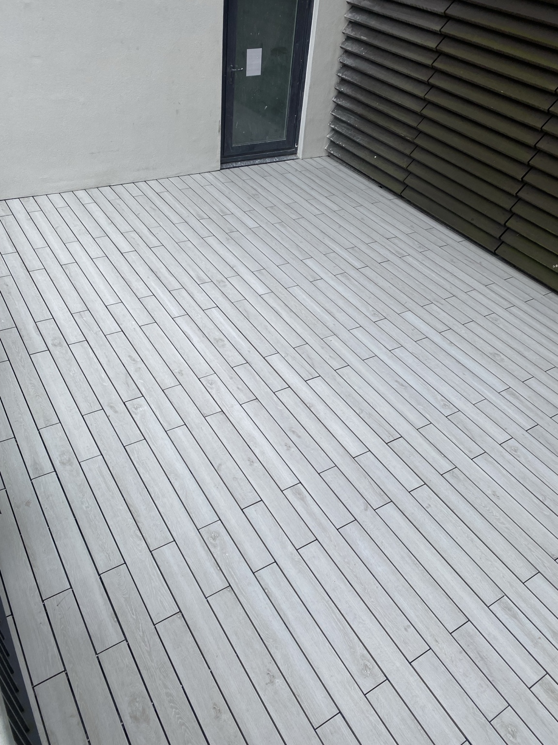 Completed grey porcelain decking installation